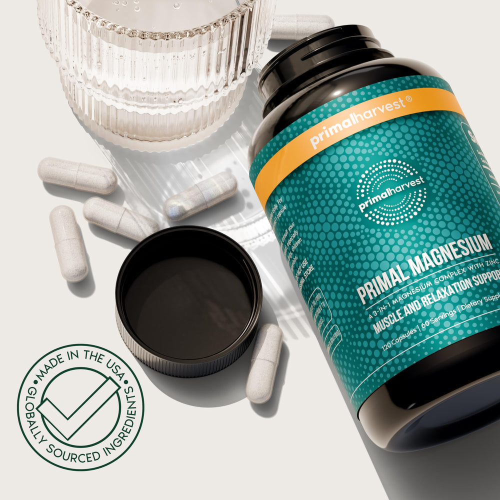 Glass of water beside Primal Harvest Magnesium Complex bottle.