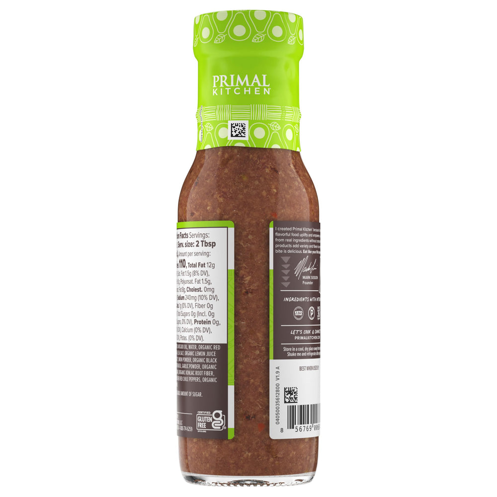 Primal Kitchen Italian Vinaigrette glass bottle on a kitchen shelf.