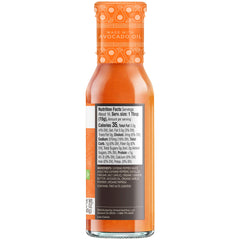 Pouring Primal Kitchen No Dairy Buffalo Sauce, smooth medium heat.