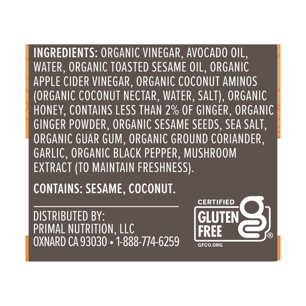 Primal Kitchen Sesame Ginger Vinaigrette on colorful salad bowl.