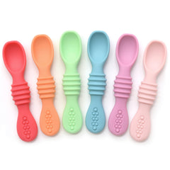 PrimaStella silicone chew spoon baby holding view promotes safe self-feeding.