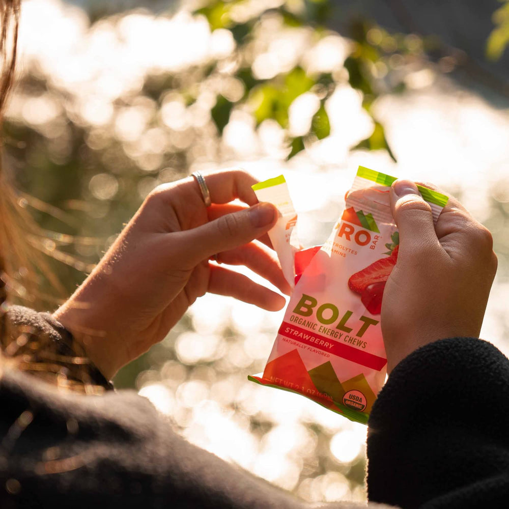 PROBAR Bolt Organic Energy Chews Strawberry box on shelf emphasizing convenient 12-count packaging.