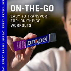 Pouring Propel grape powder into water for refreshing, sugar-free hydration.