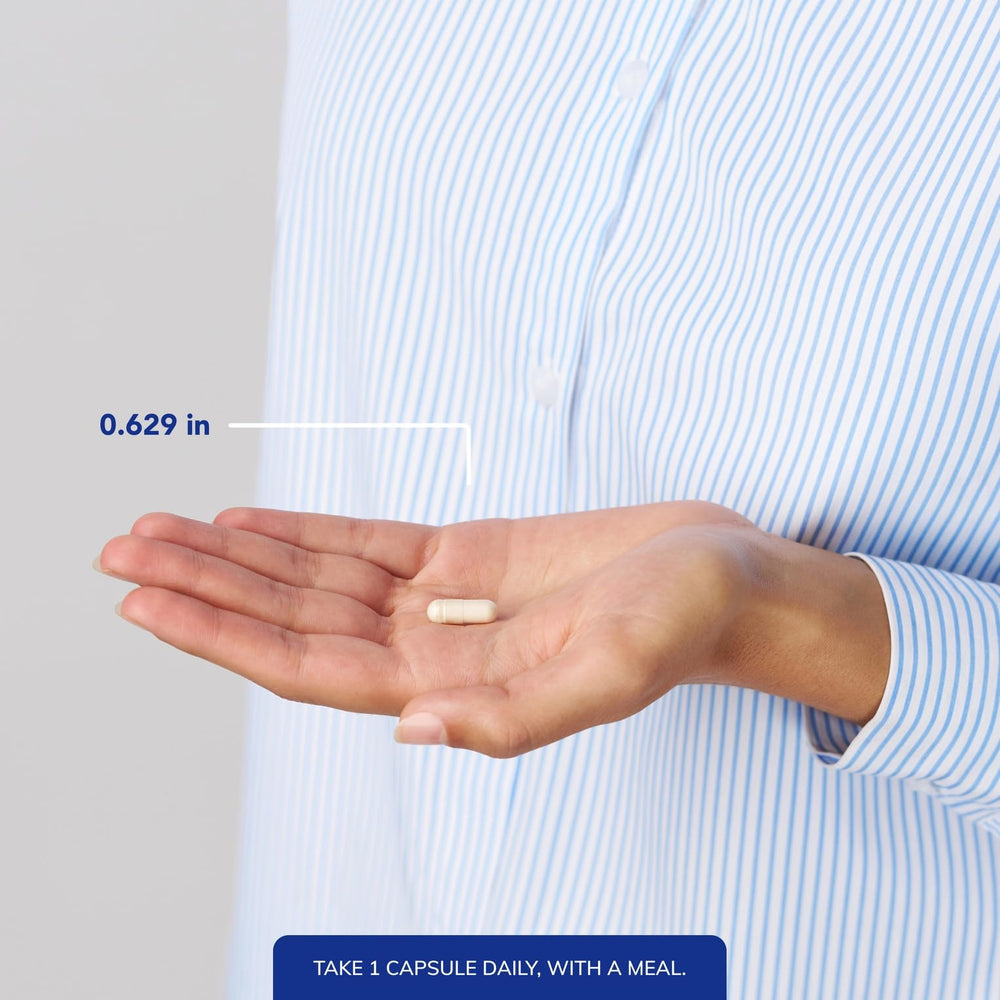 Person taking Pure Encapsulations DHEA 25 mg capsule for daily energy.