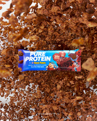Crunchy, cereal-milk texture of Pure Protein Cocoa PEBBLES bar