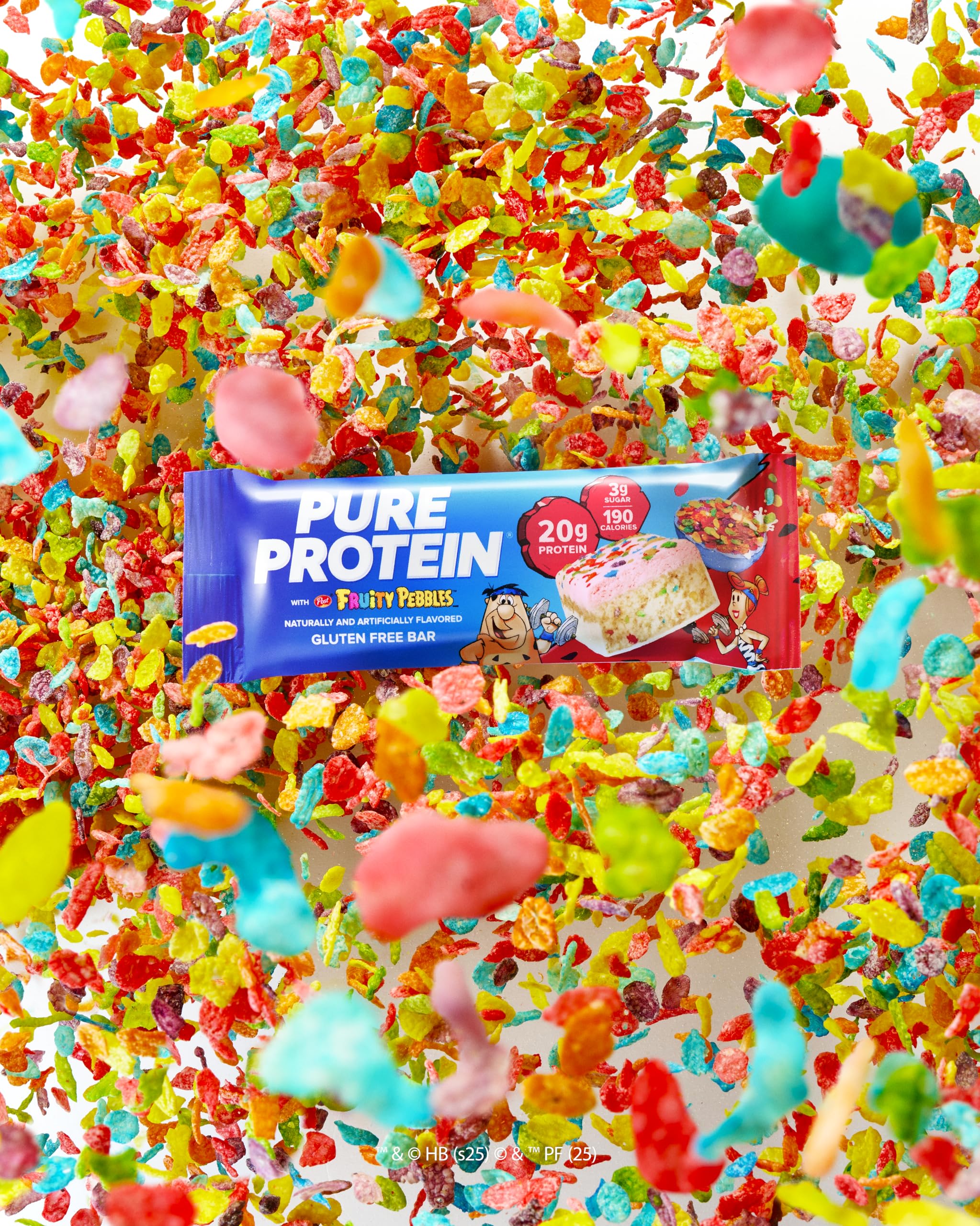 Pure Protein Fruity PEBBLES Bar split to reveal soft interior and flavor.