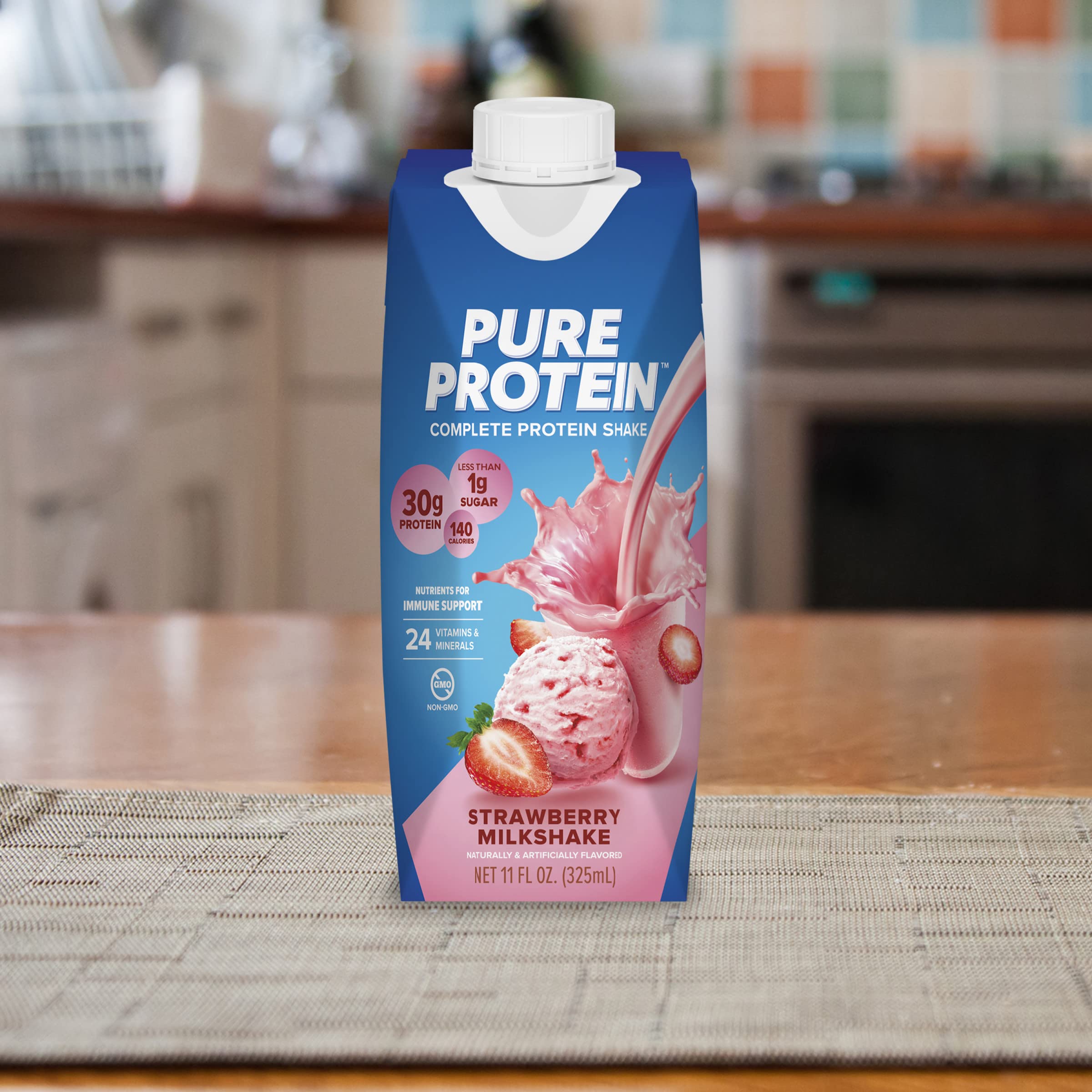 Person on the go enjoying a Pure Protein Strawberry Shake.