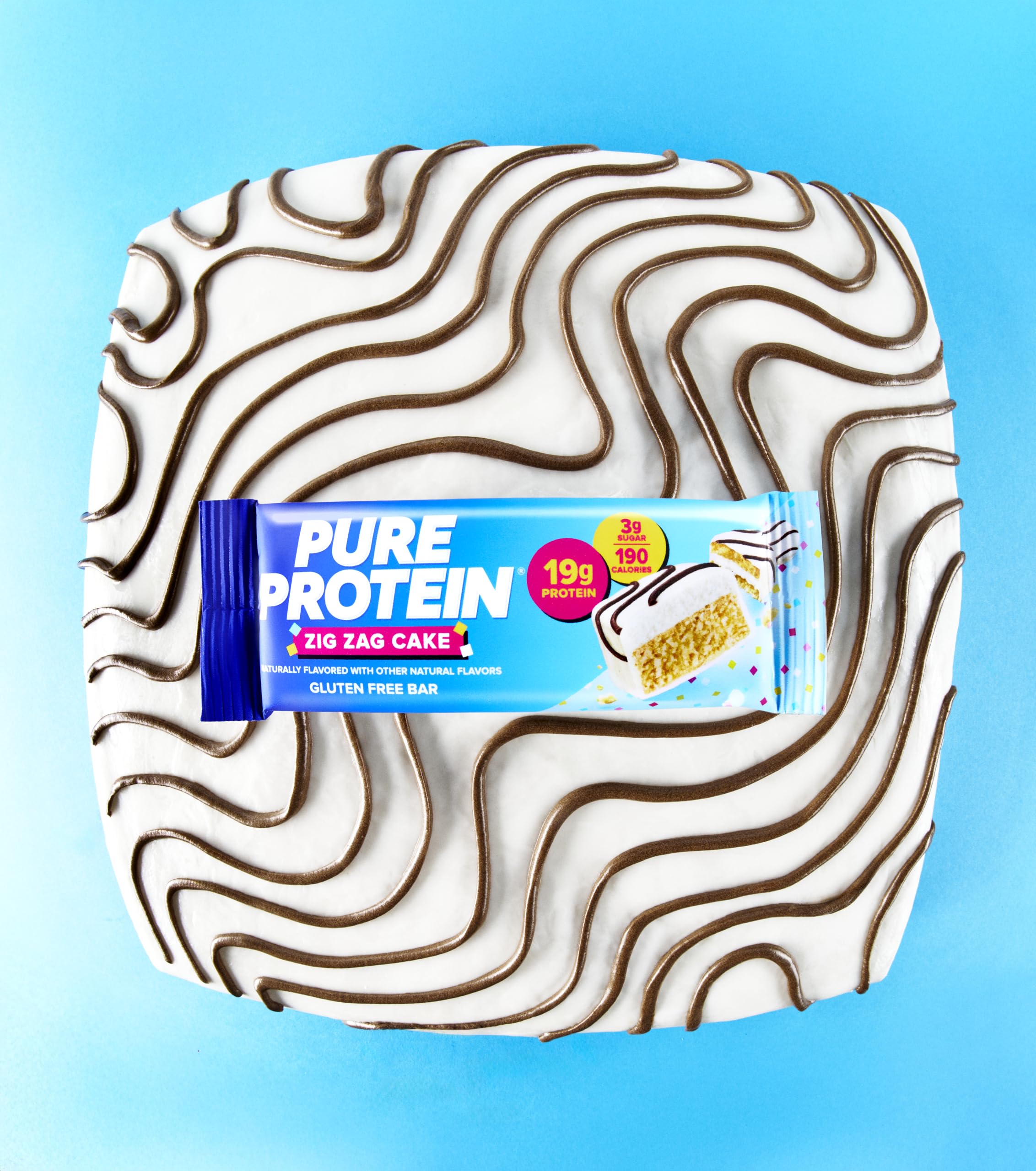 Pure Protein Zig Zag Cake Bar with gluten-free symbol on packaging.