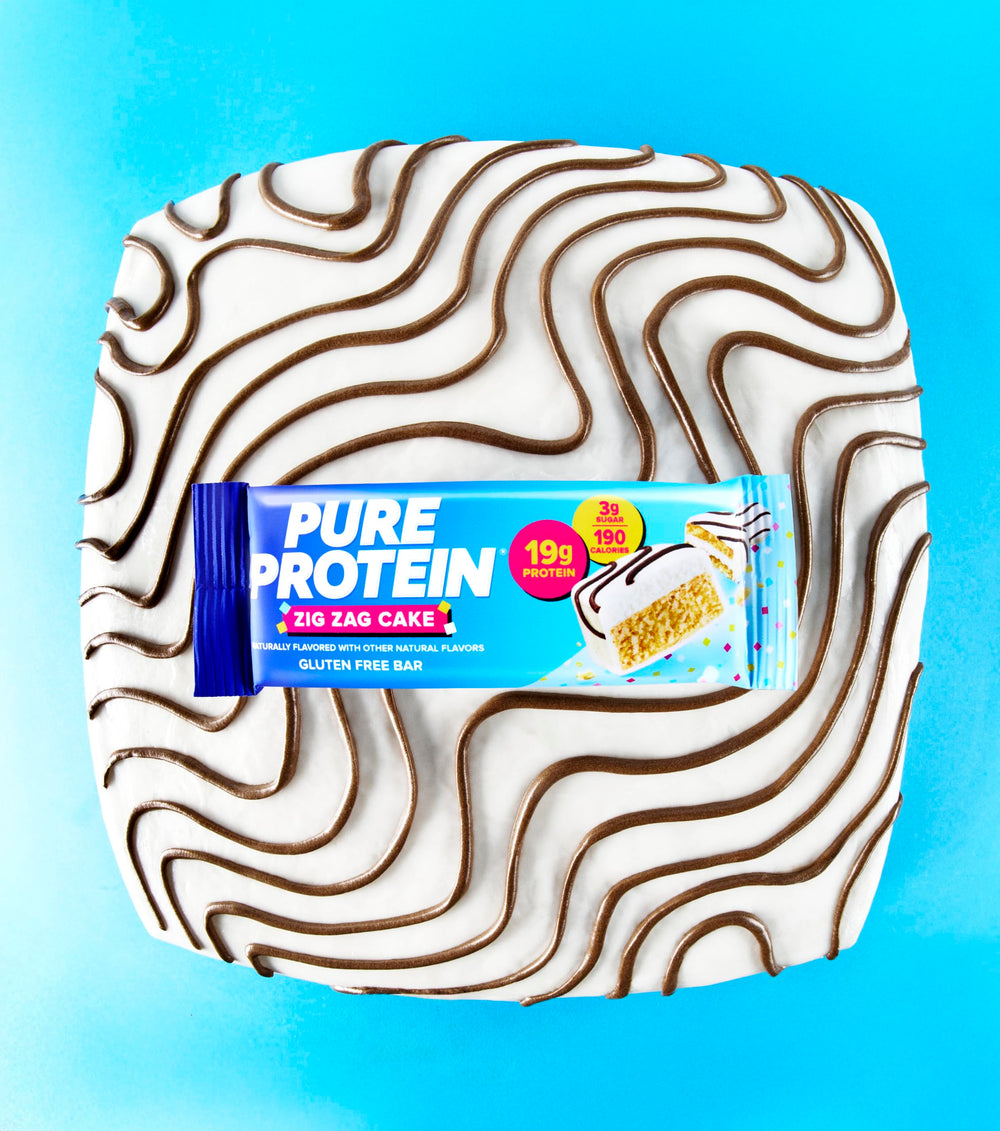 Pure Protein Zig Zag Cake Bar with gluten-free symbol on packaging.