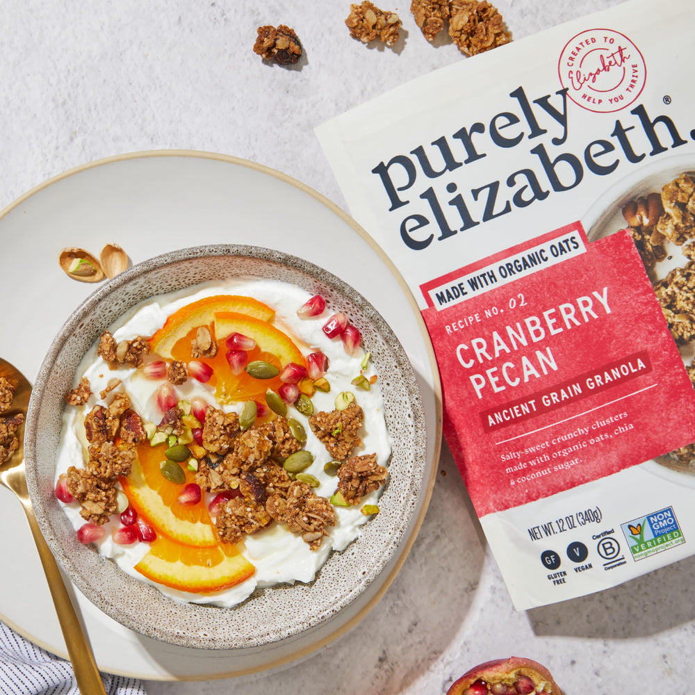Purely Elizabeth Cranberry Pecan Granola served with milk for a quick nourishing start.