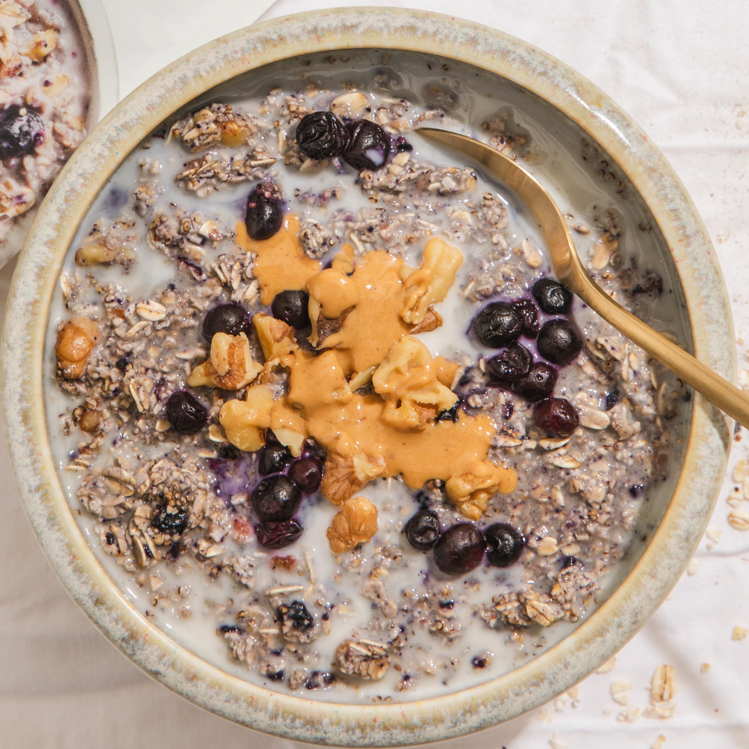 Purely Elizabeth overnight oats setup with blueberries and walnuts.