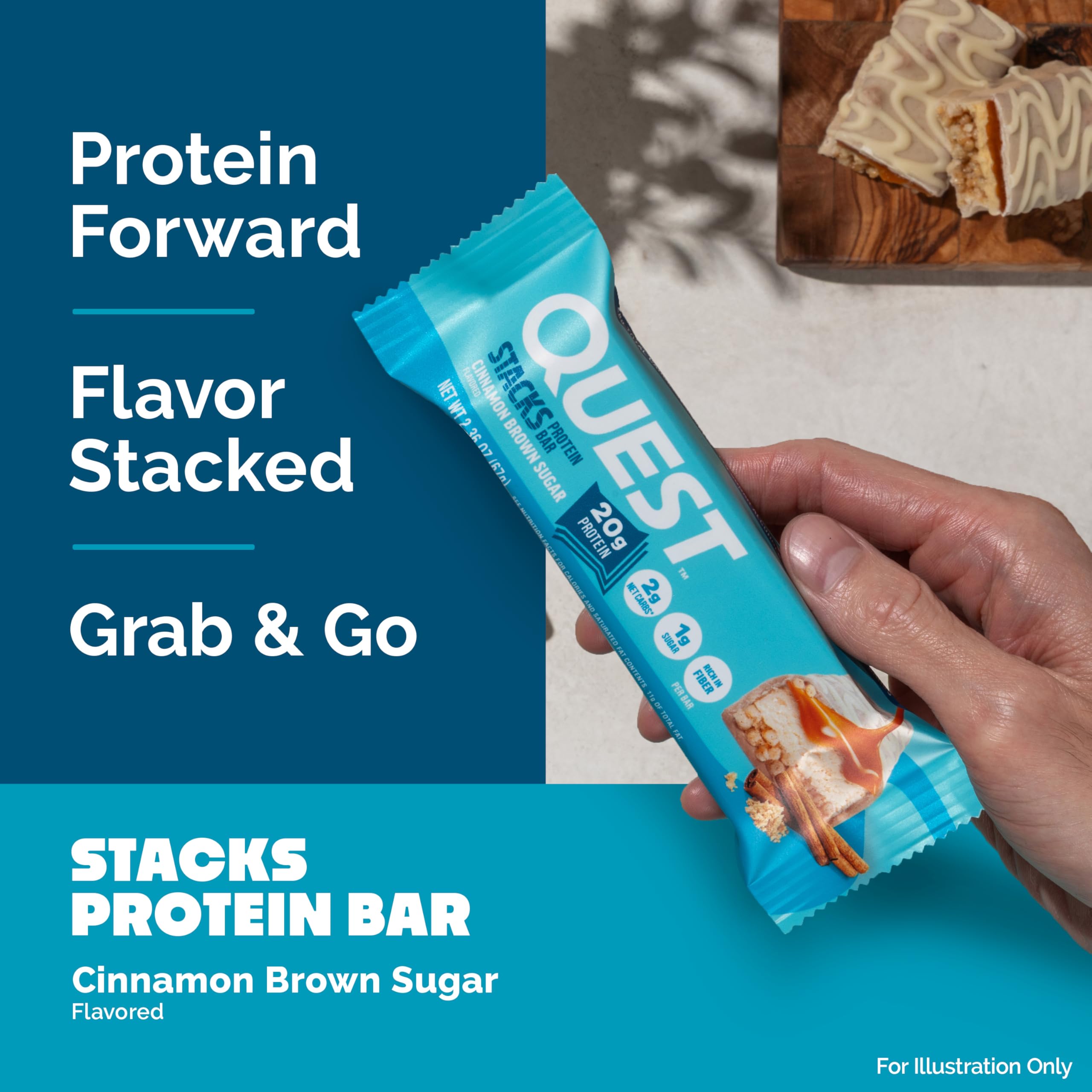 Quest Stacks Cinnamon Brown Sugar bar on desk suggests convenient office snacking.