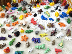 Random 3D-printed animals mini figurine with articulated joints for pose play.