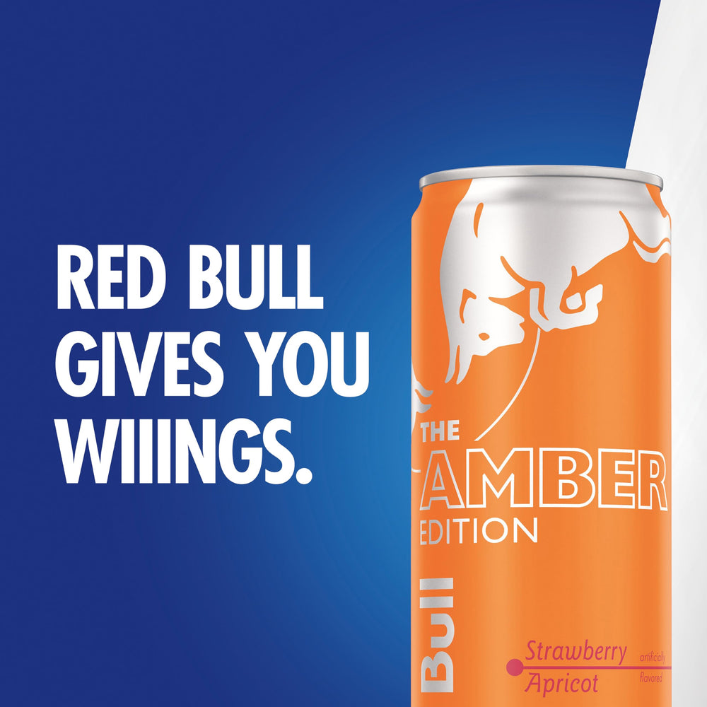Traveler grabbing Red Bull Amber Edition from a backpack