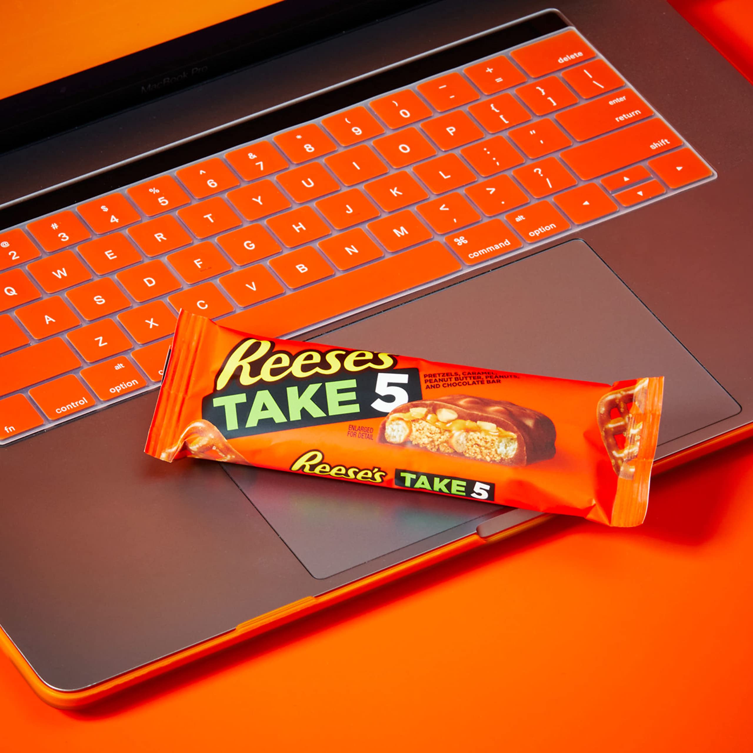 REESE'S Take 5 bars arranged on desk ideal for quick office treats.