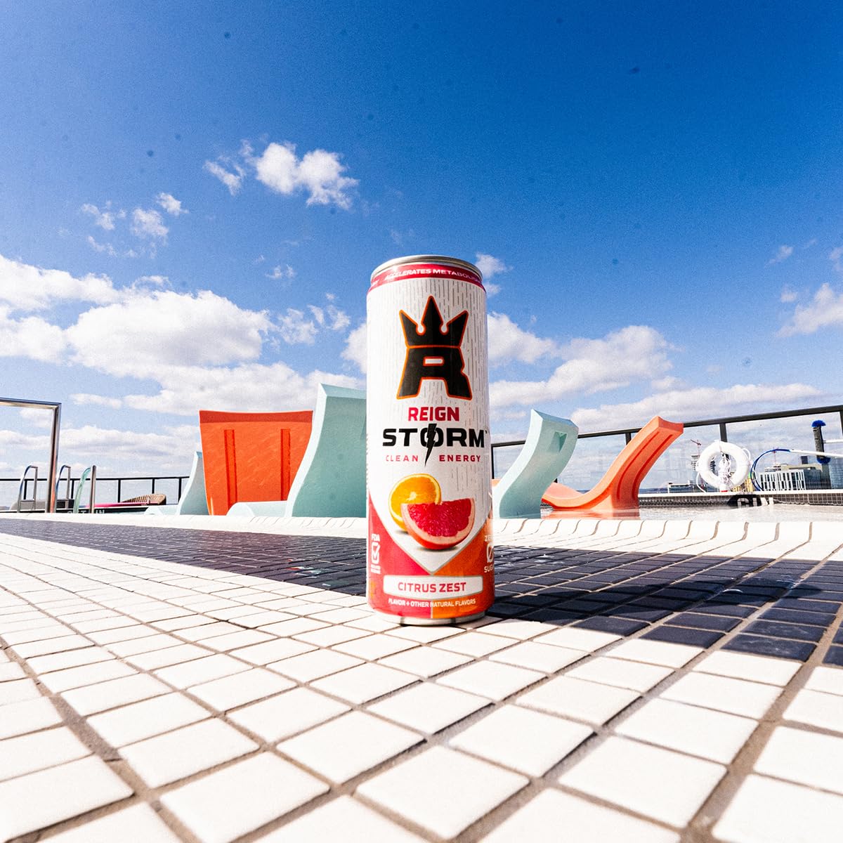 REIGN Storm Citrus Zest resting on a gym bag suggests on-the-go energy.