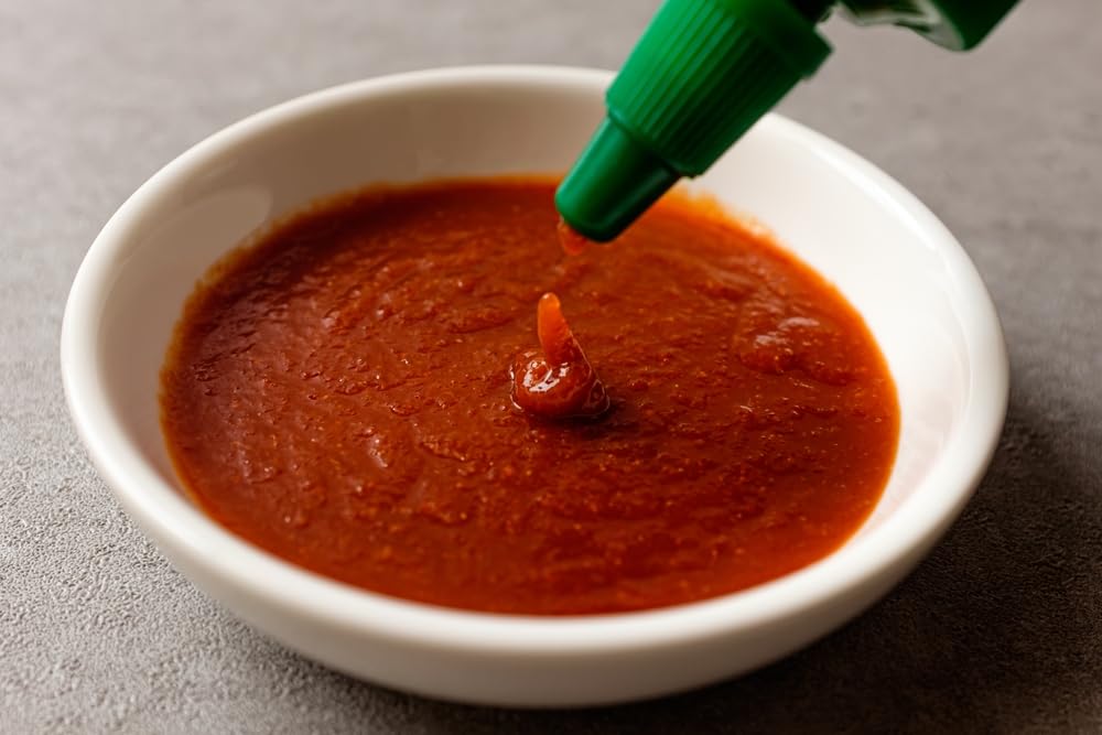 Rex Sriracha with noodles creates tangy heat in a bowl.