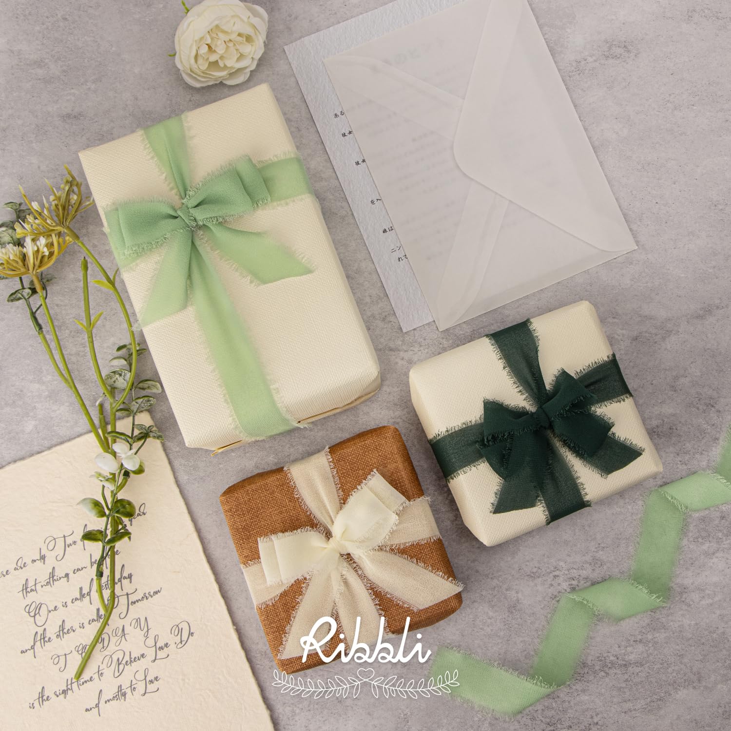 Ribbli fringe chiffon ribbon wrapped around a wedding invitation for instant elegance