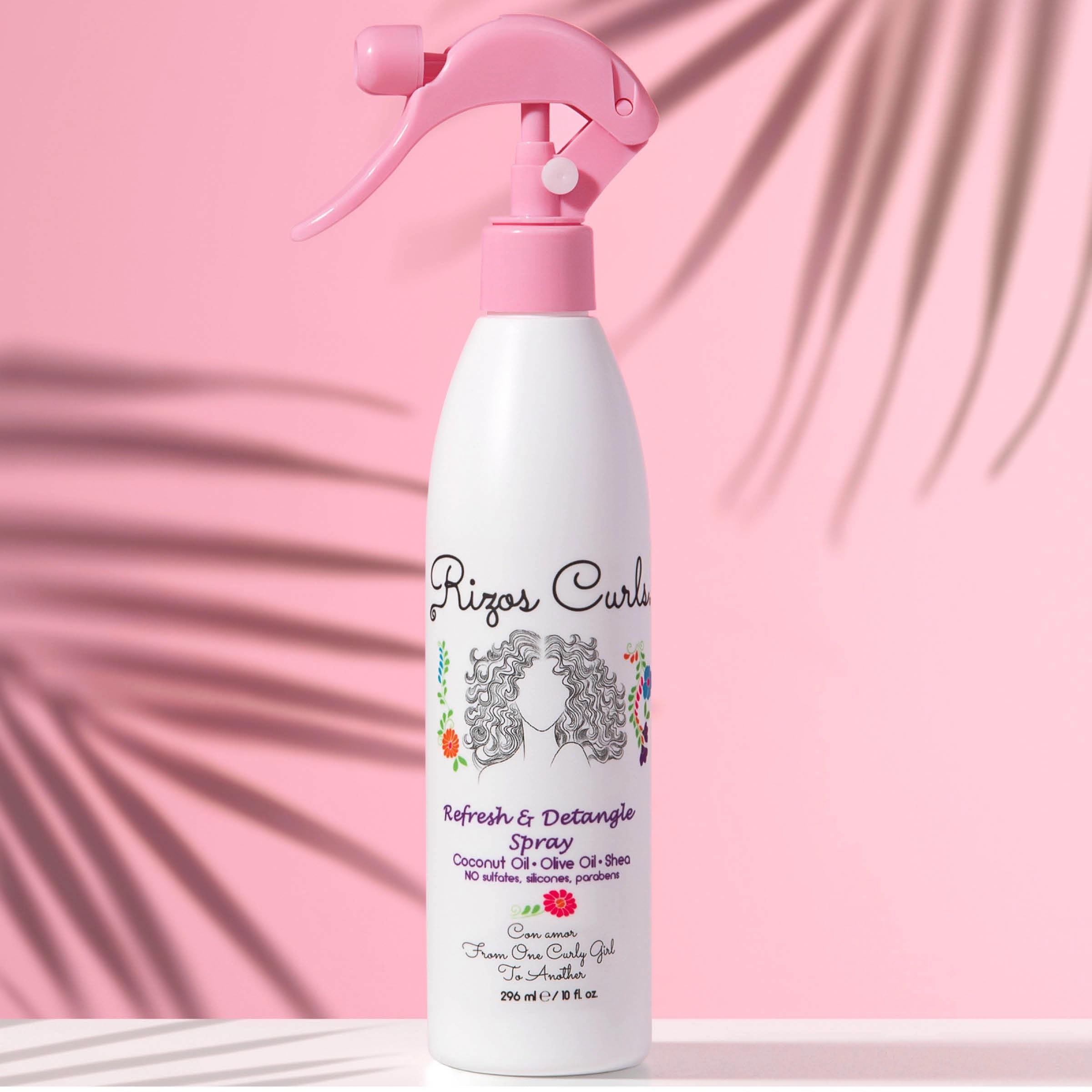 Close-up of Rizos Curls Refresh & Detangle Spray bottle detailing nourishing ingredients.