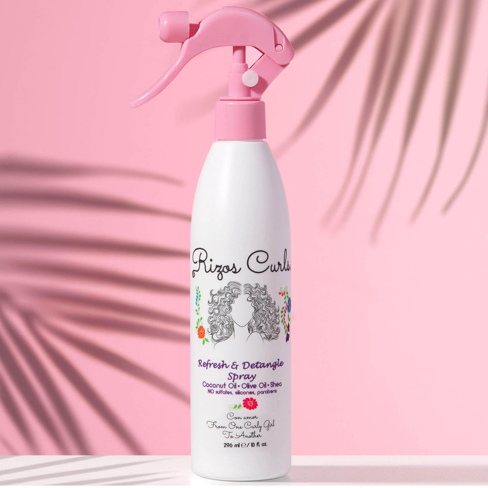 Close-up of Rizos Curls Refresh & Detangle Spray bottle detailing nourishing ingredients.