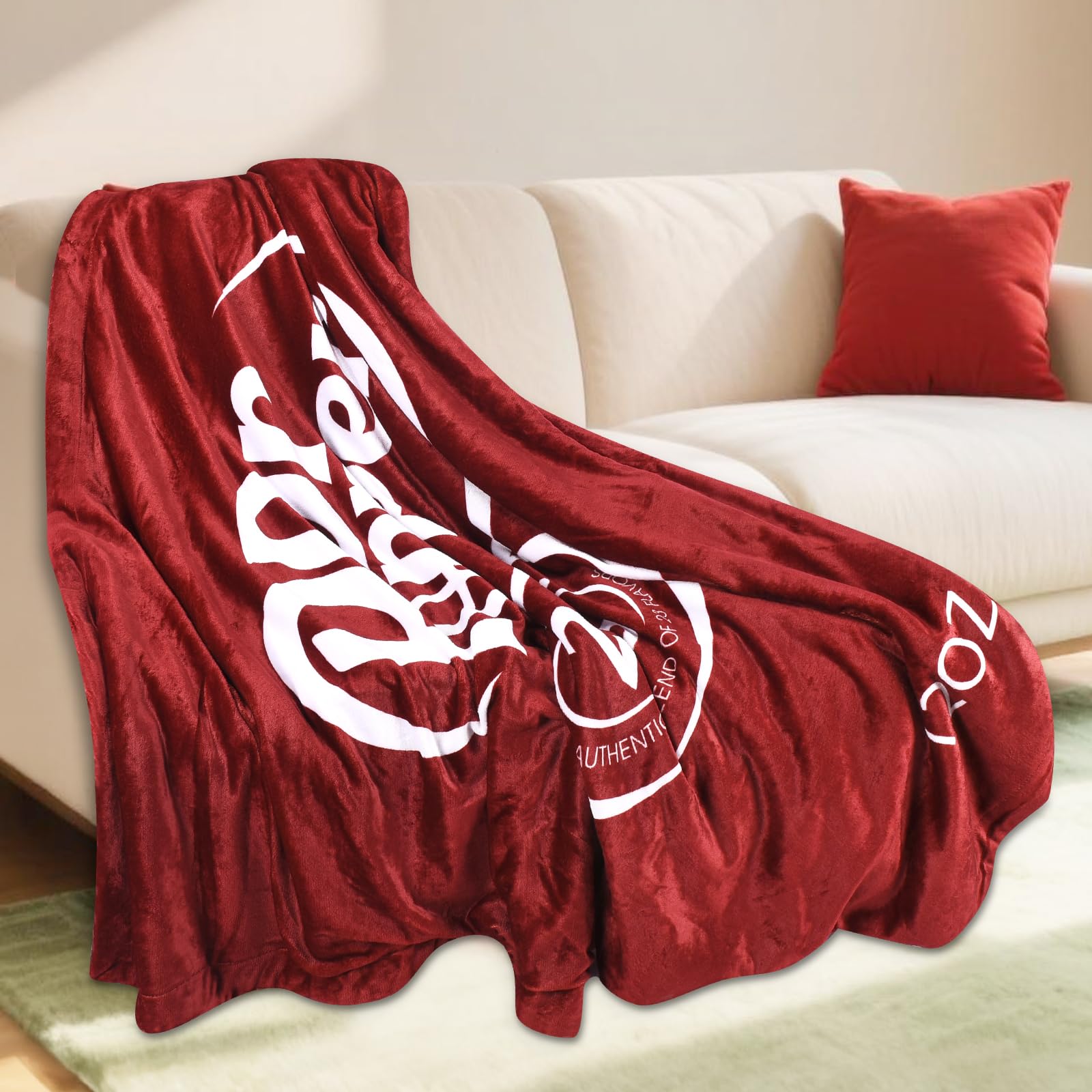 RMKA Dr Pepper blanket laid in a car seat provides lightweight warmth.