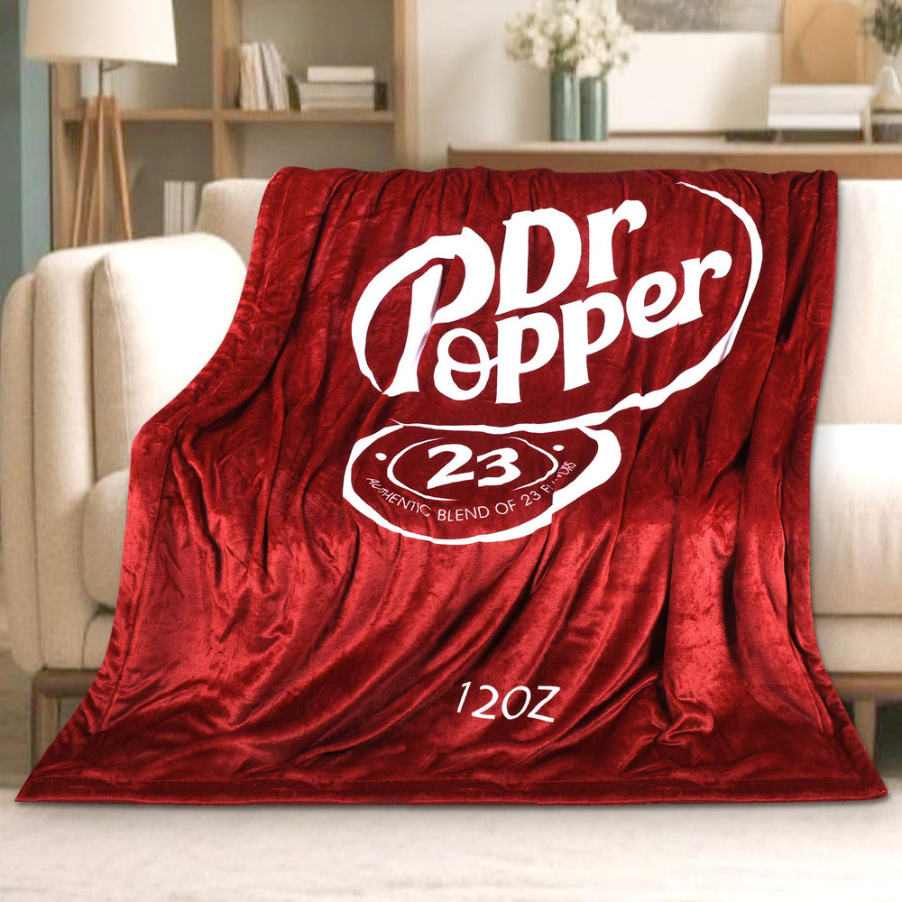 RMKA Dr Pepper blanket logo closeup highlights vibrant print and soft fleece texture.