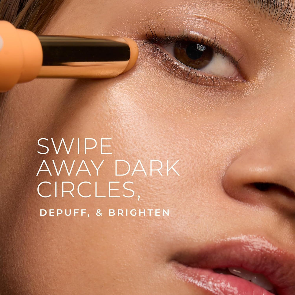 RoC revive glow eye balm under-eye application close-up showing the touchless wand