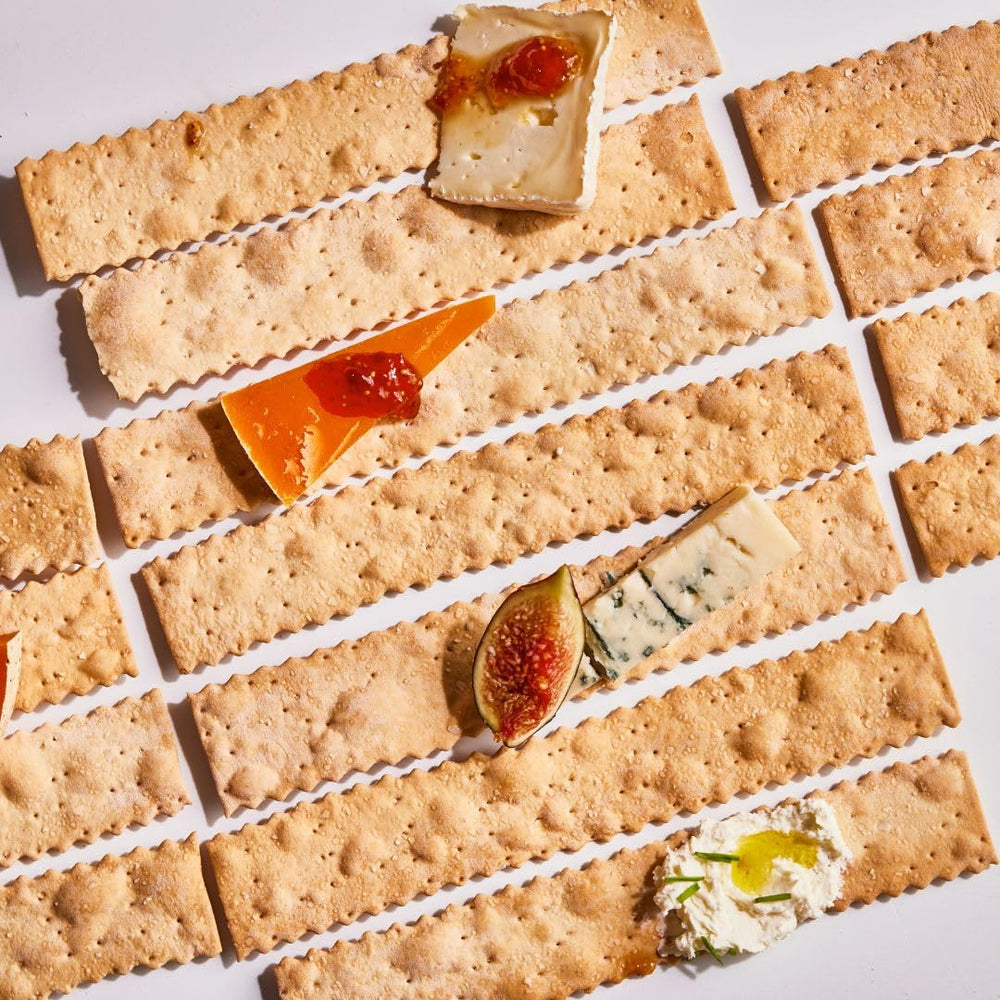 Rustic Bakery cheese board pairing crackers with soft cheese for tasting