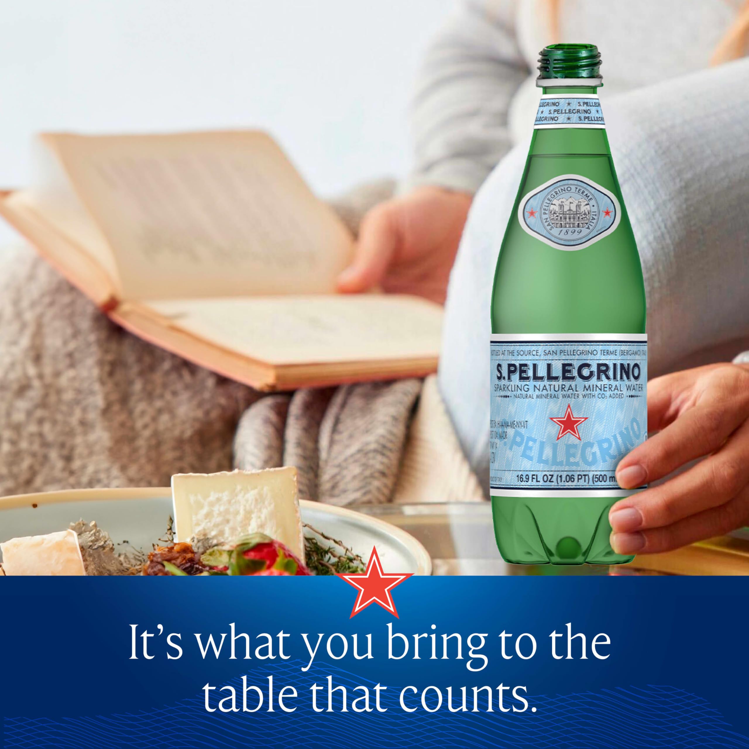 S.Pellegrino bottle on table beside gourmet dishes, inviting dinner
