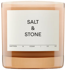 Salt & Stone saffron cedar candle jar creates a warm, inviting ambience.