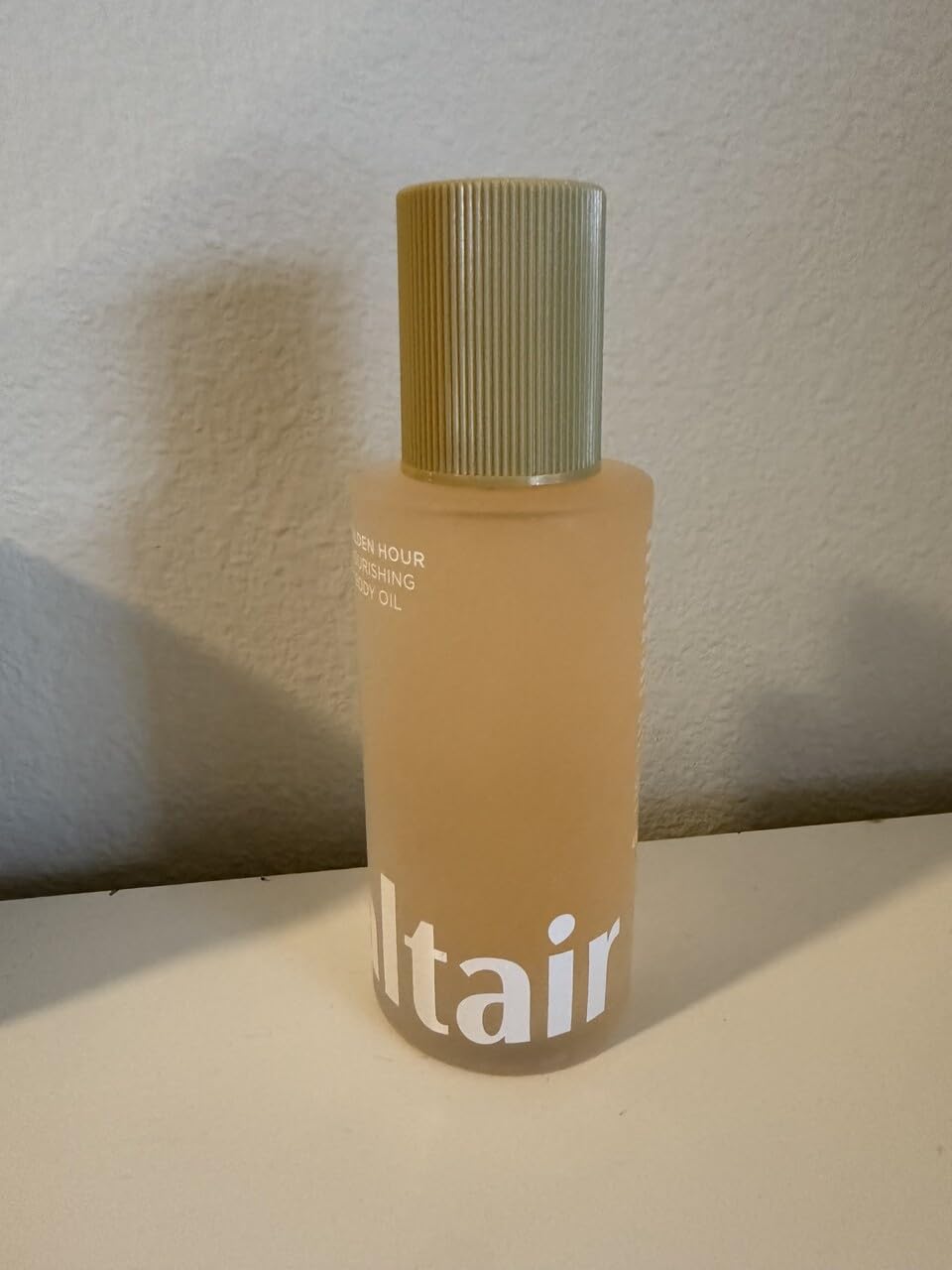Saltair Body Oil pump shows easy, quick absorption on skin.