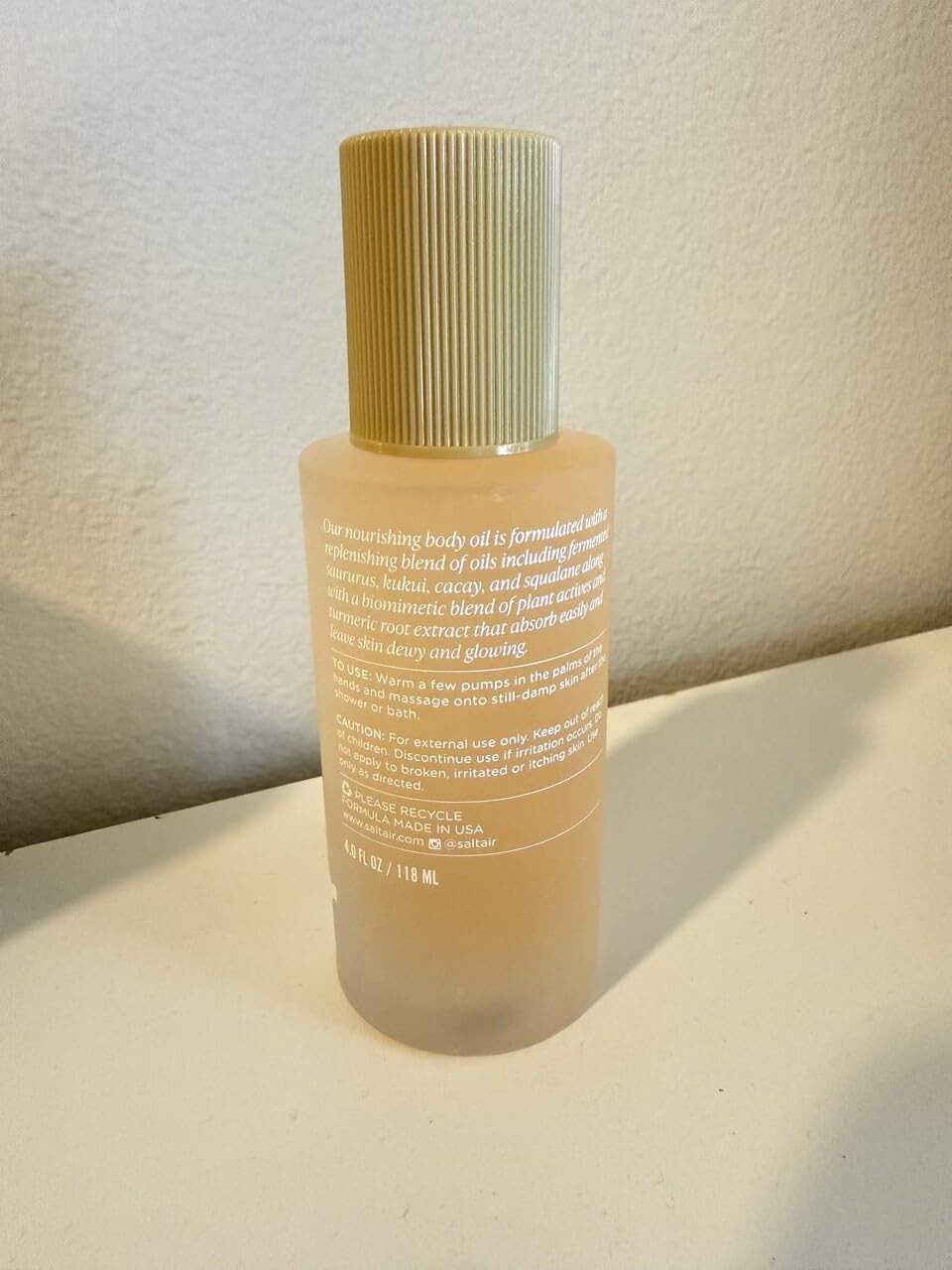 Close-up of Saltair Body Oil's silky texture promises smooth, non-greasy hydration.