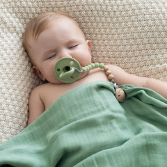 SAMiGO pacifier clips on clothing illustrate strong clasp preventing drops.