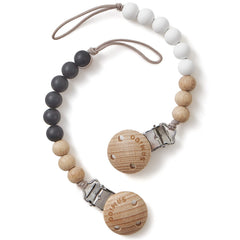 SAMiGO silicone pacifier clip in black and white securely attaches to clothing.
