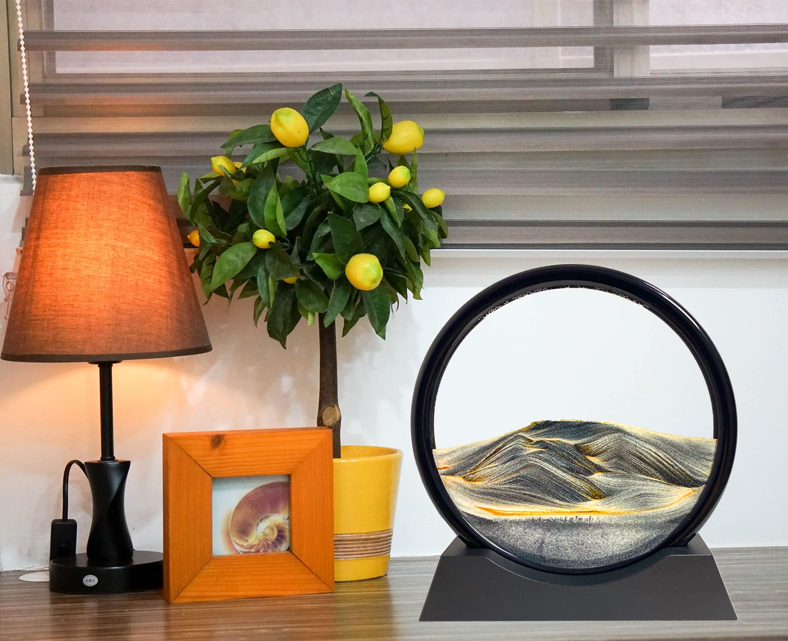 SANDCLE liquid motion sand art on a display stand for desk use.