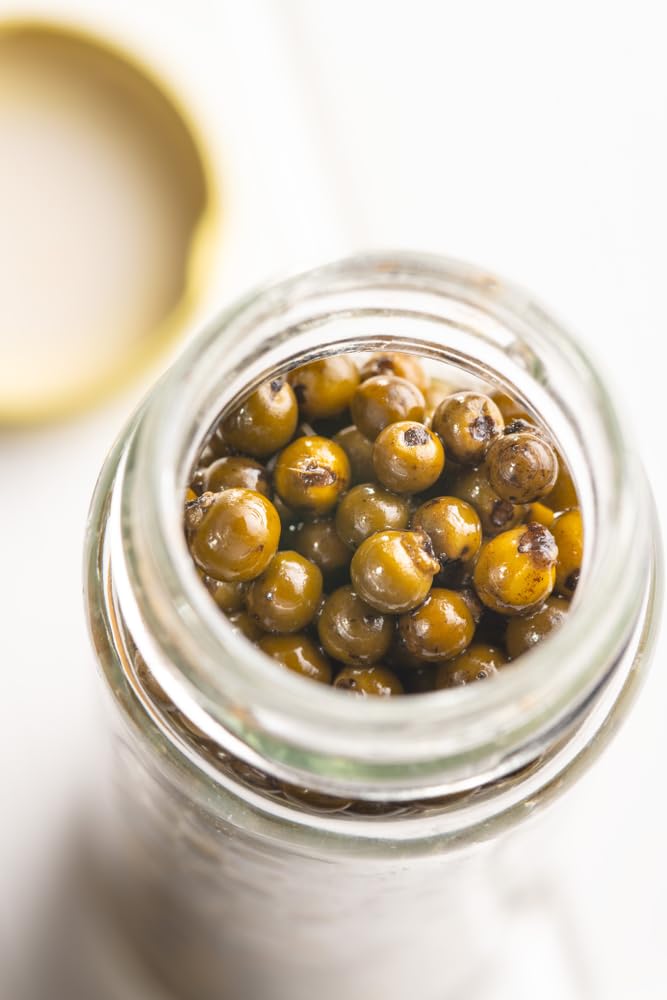 Close up of Sanniti green peppercorns in brine, adds brightness to soups.