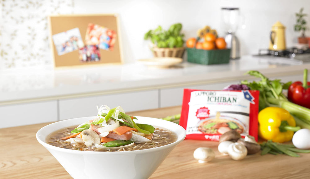 Close-up of ramen ingredients, showcasing noodles and flavor packets.