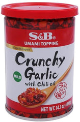 Pouring S&B Chili Oil with Crunchy Garlic for ramen and sushi drizzle.