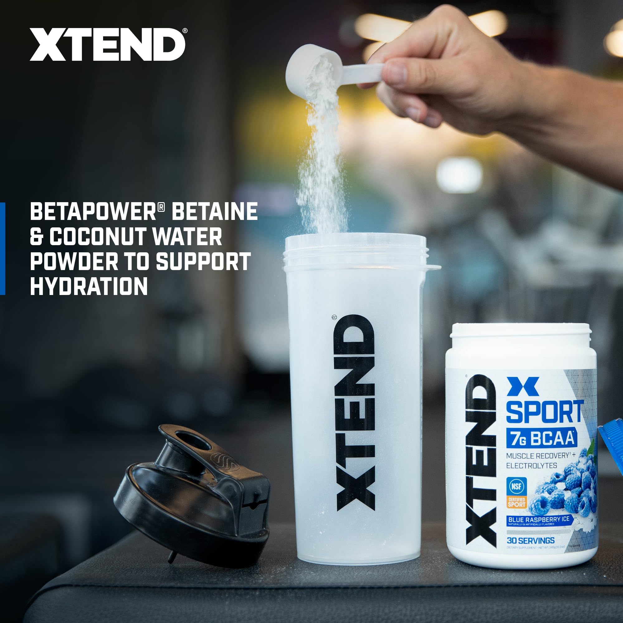 XTEND Sport Blue Raspberry Ice powder ready in a shaker for on-the-go hydration.