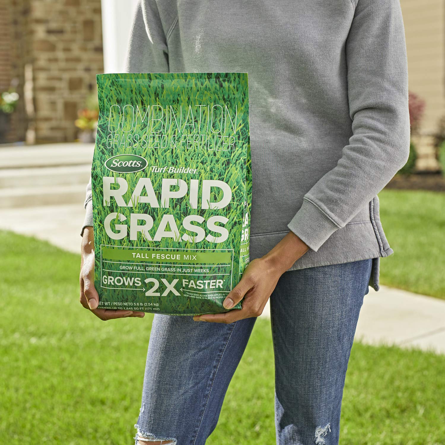 Scotts Turf Builder Rapid Grass seeds being spread across a prepared lawn.