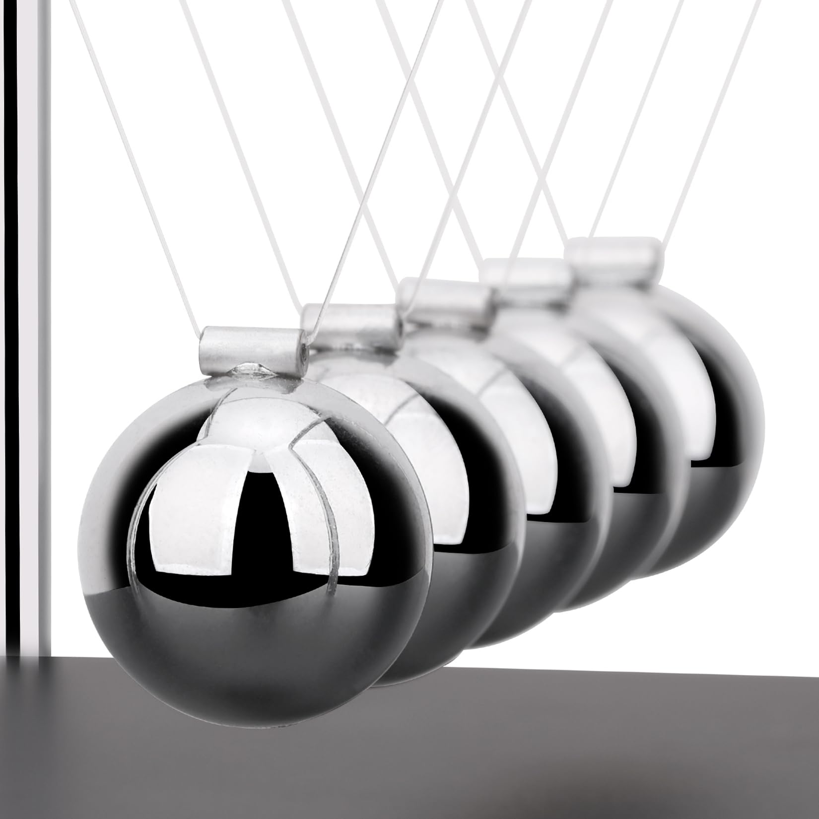 SEVNPRIME wooden-base cradle combines stylish design with kinetic science on a workspace.