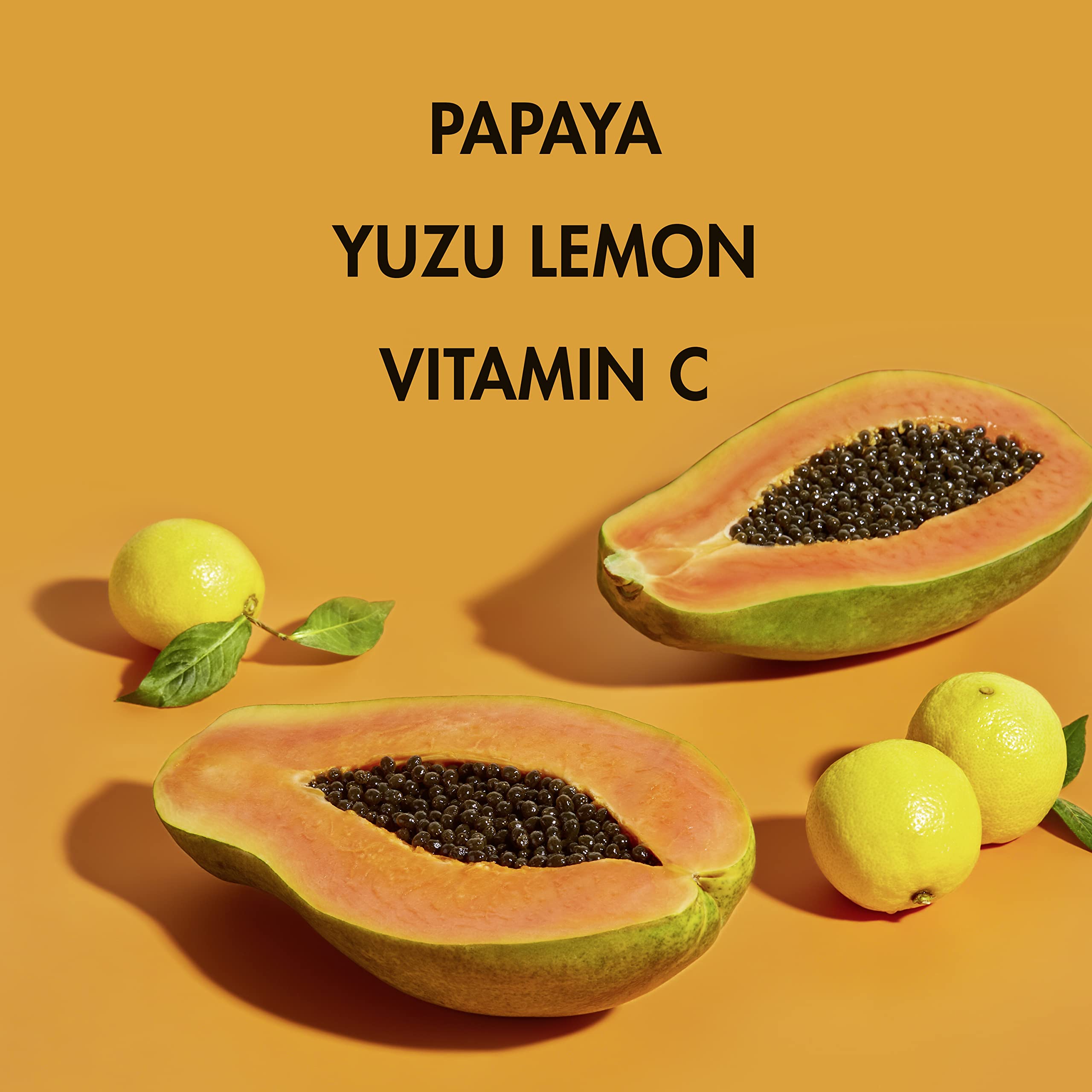 Papaya fruit beside serum bottle suggests natural ingredients and fresh glow.