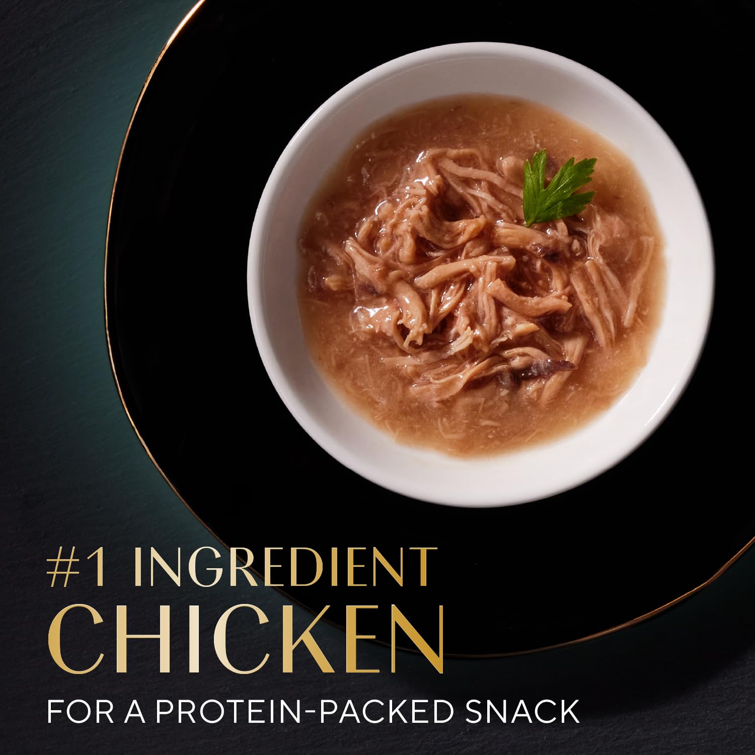 Sheba Selections Filets in Broth topping shown over cat food to enhance flavor.