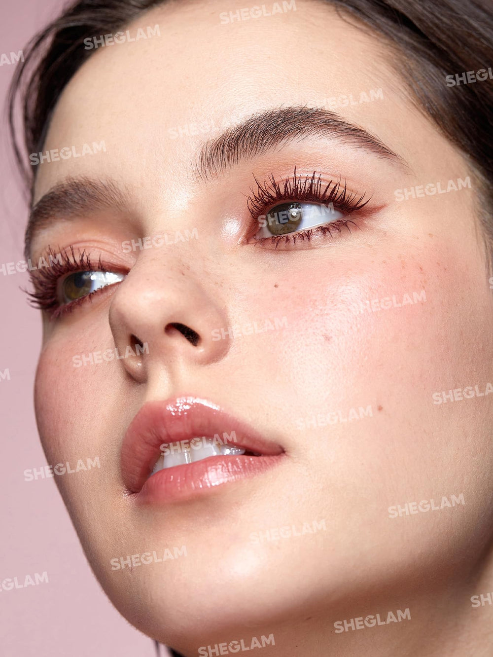 SHEGLAM mascara wand shows curved and hourglass brush design for lift, curl, and separation.