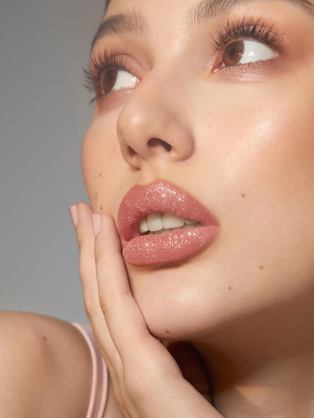 Close-up of SHEGLAM Lip Dazzler glitter particles catching light for radiant sparkle.