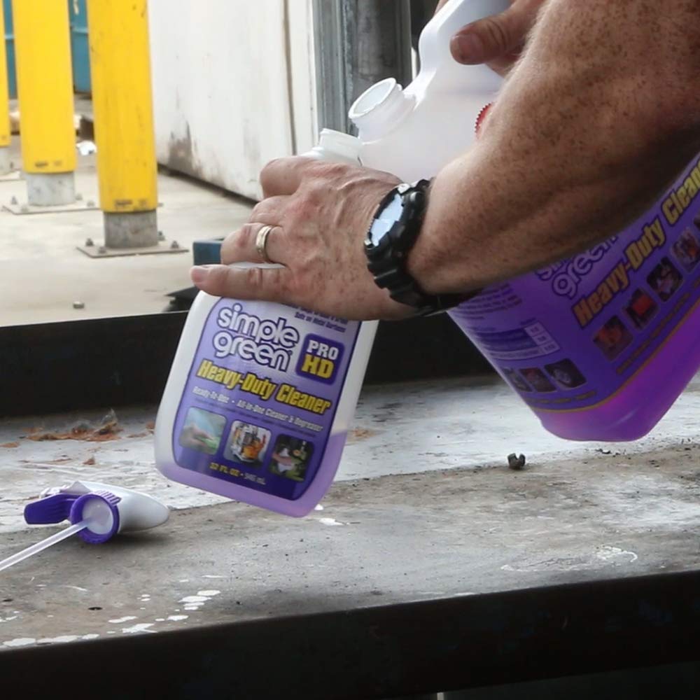 Simple Green Pro HD Purple applied to industrial equipment for grime removal.
