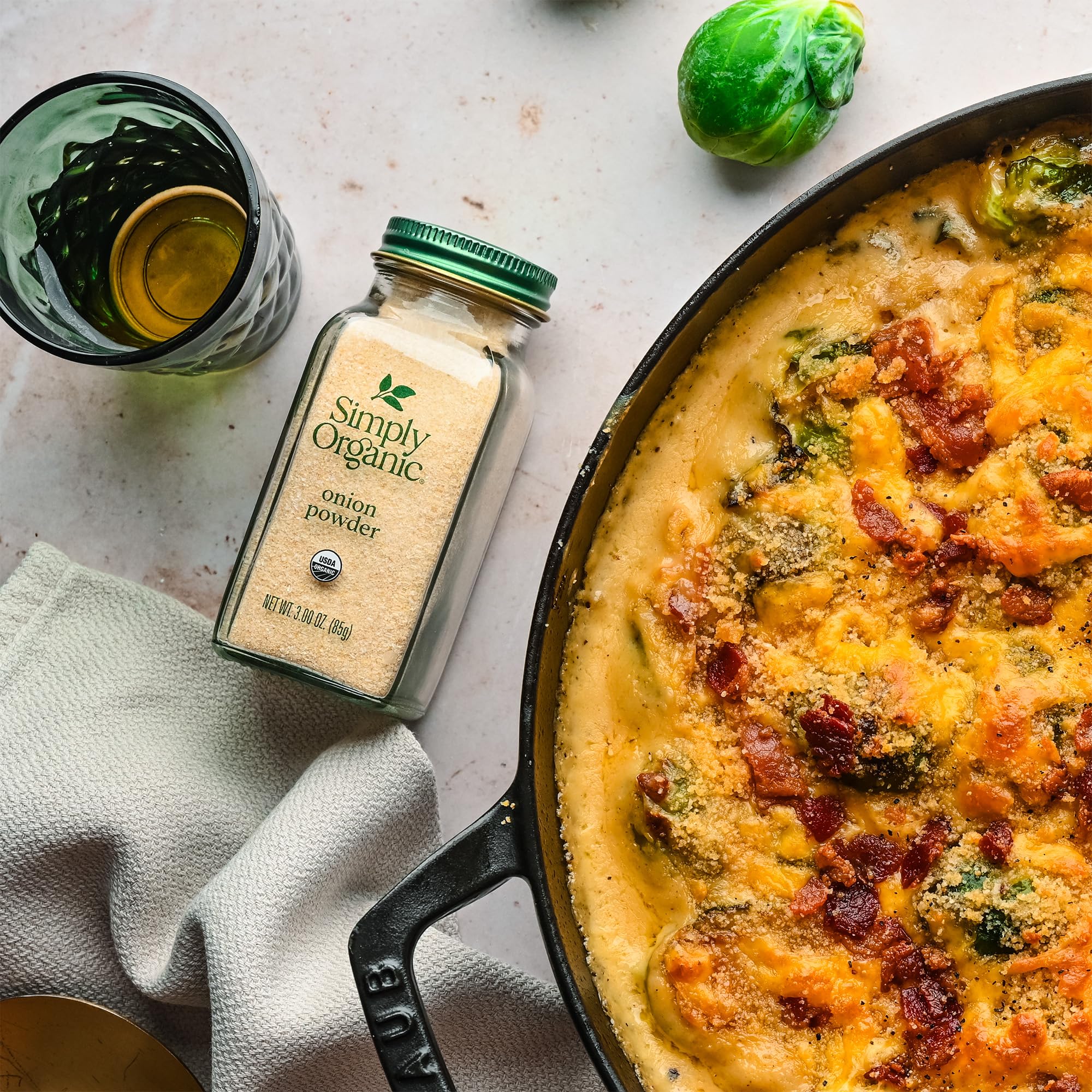 Simply Organic White Onion Powder on dish emphasizes its versatility as a kitchen staple.