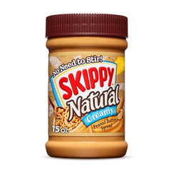 SKIPPY jar with cracked peanut pieces highlighting chunky texture.