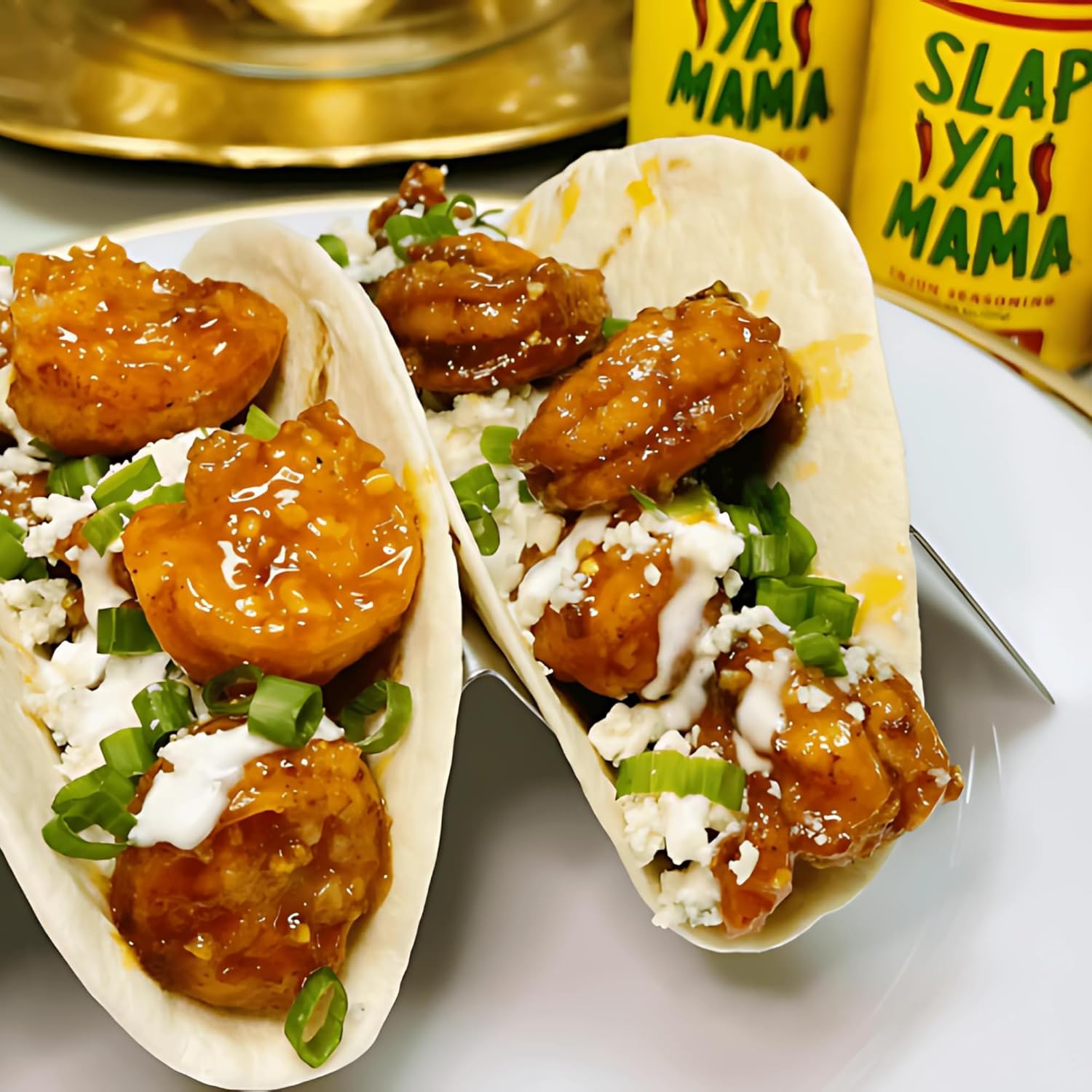 Slap Ya Mama Cajun spice rack display in a kitchen setting.