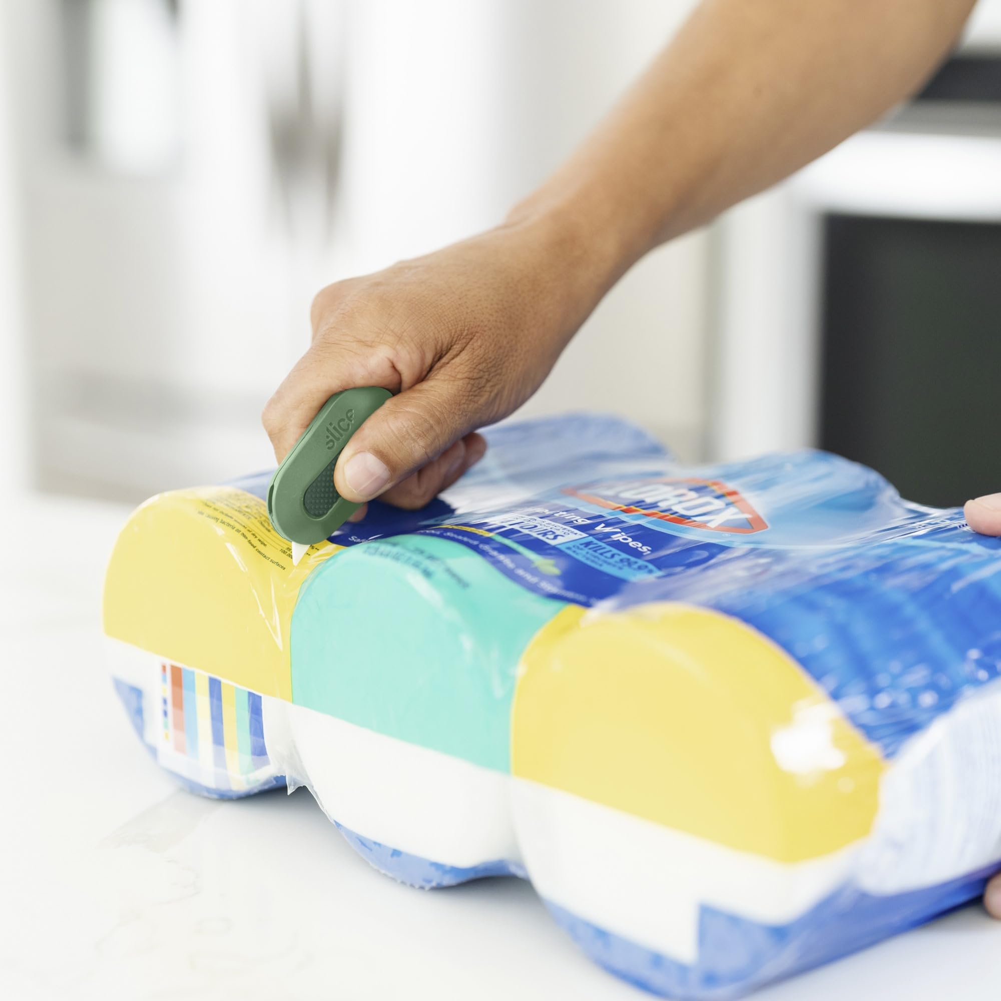 Slice Mini Box Cutter magnet on fridge enables quick access.